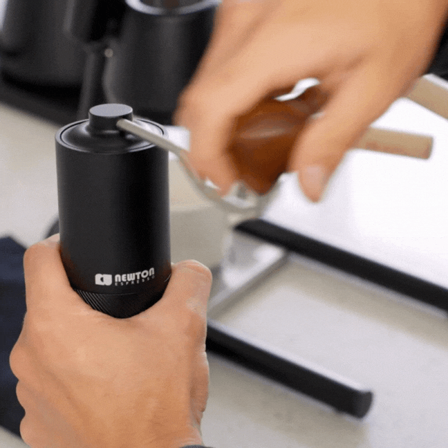 Manual hand operated coffee grinder in action